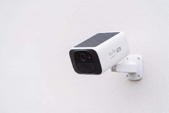 A single white eufy Security 2K camera mounted on a wall bracket, angled outward against a pale grey wall.