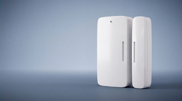 A Kept two-piece wireless door sensor, the magnet beside the main body.